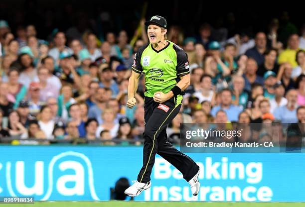 Shane Watson of the Thunder celebrates taking the catch to dismiss Ben Cutting of the Heat during the Big Bash League match between the Brisbane Heat...