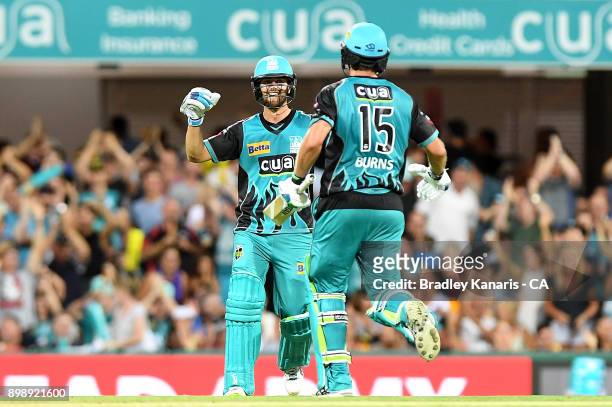 Joe Burns and Alex Ross of the Heat celebrate victory after the Big Bash League match between the Brisbane Heat and the Sydney Thunder at The Gabba...