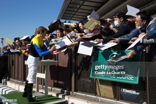 Ryan Moore gives his autograph to Japanese racing fans after he reaching 100th JRA victory at Tokyo Racecourse on November 25, 2017 in Tokyo, Japan.