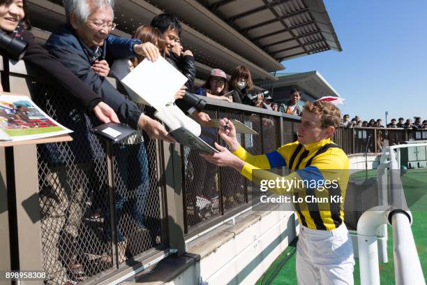 Ryan Moore gives his autograph to Japanese racing fans after winning Race 3 at Tokyo Racecourse on November 25, 2017. Ryan Moore picked up a...