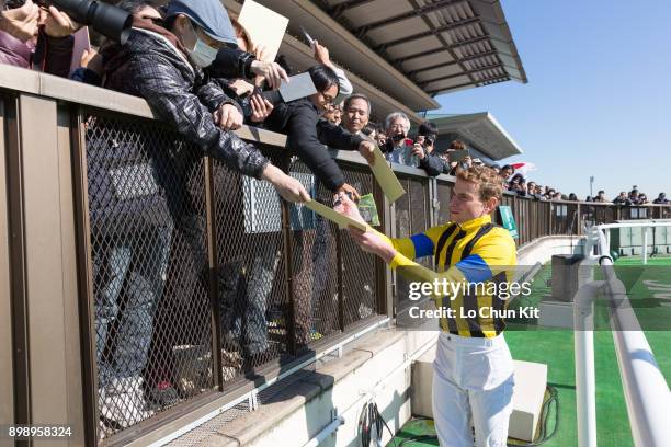 Ryan Moore gives his autograph to Japanese racing fans after winning Race 3 at Tokyo Racecourse on November 25, 2017. Ryan Moore picked up a...