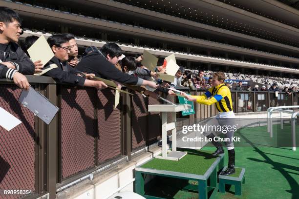 Ryan Moore gives his autograph to Japanese racing fans after winning Race 3 at Tokyo Racecourse on November 25, 2017. Ryan Moore picked up a...