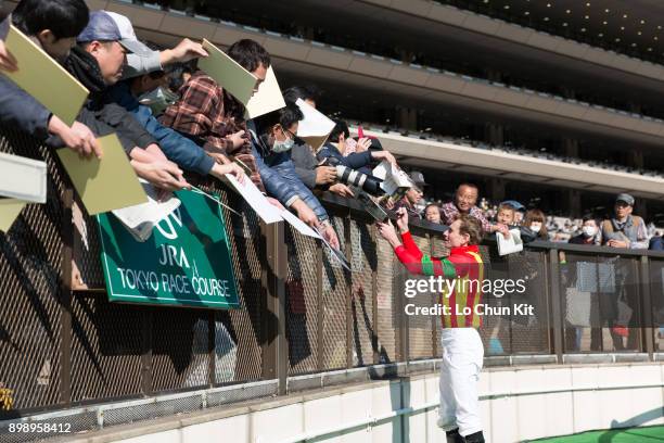 Ryan Moore gives his autograph to Japanese racing fans after winning Race 5 at Tokyo Racecourse on November 25, 2017. Ryan Moore picked up a...