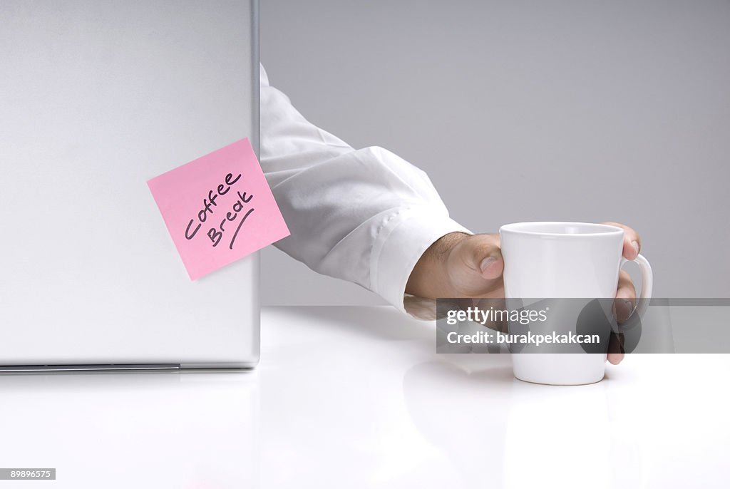 Uomo d'affari che tiene una tazza da caffè