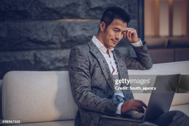 handsome man using laptop - person surfing the internet stock pictures, royalty-free photos & images