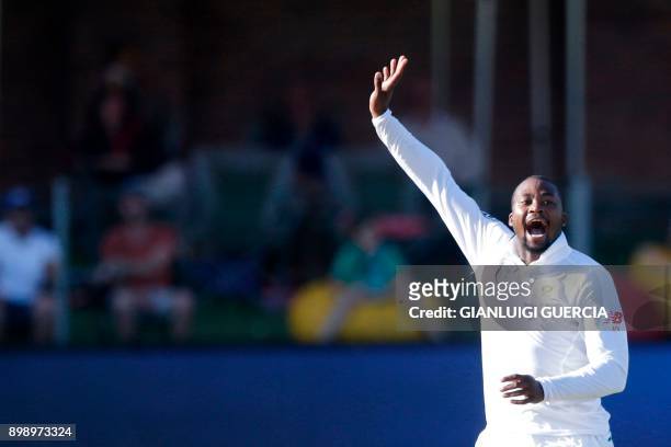 South African bowler Andile Phehlukwayo celebrates the dismissal of Zimbabwean batsman Peter Moor during the second day of the day-night Test cricket...