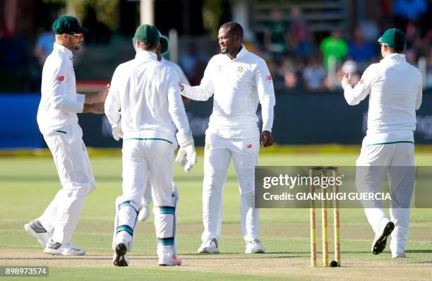 South African bowler Andile Phehlukwayo celebrates the dismissal of Zimbabwean batsman Peter Moor during the second day of the day-night Test cricket...