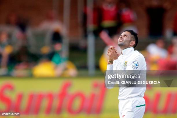 South African bowler Keshav Maharaj celebrates the dismissal of Zimbabwean batsman Blessing Muzarabani during the second day of the day-night Test...