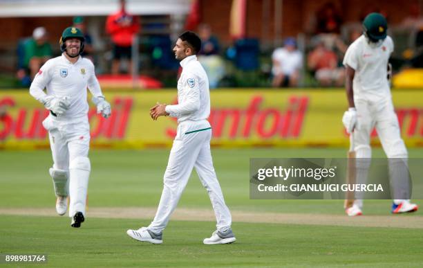 South African bowler Keshav Maharaj celebrates the dismissal of Zimbabwean batsman Blessing Muzarabani during the second day of the day-night Test...