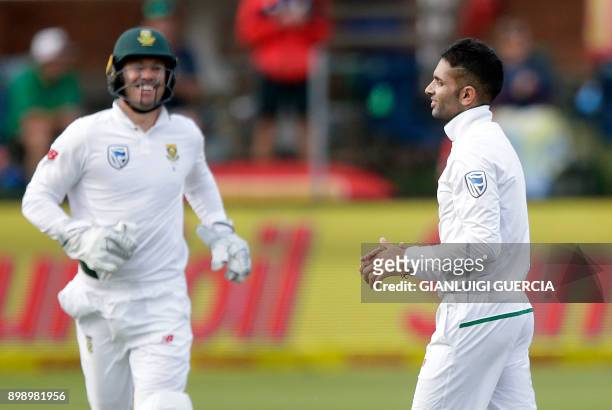 South African bowler Keshav Maharaj celebrates the dismissal of Zimbabwean batsman Blessing Muzarabani during the second day of the day-night Test...
