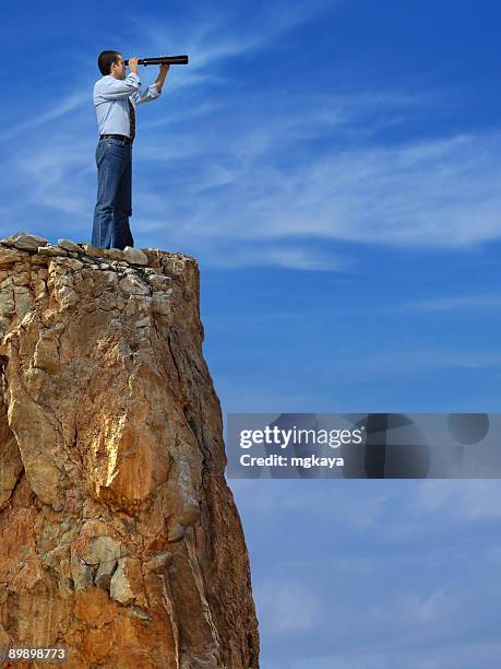 man standing on the top of a hill looking away - guess jeans stock pictures, royalty-free photos & images