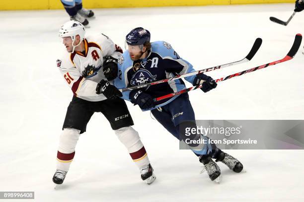 Cleveland Monsters defenceman Andre Benoit defends Milwaukee Admirals left wing Pierre-Cedric Labrie during the third period of the American Hockey...