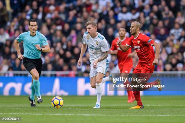 Toni Kroos of Real Madrid in action against Guido Pizarro of Sevilla FC during La Liga 2017-18 match between Real Madrid and Sevilla FC at Santiago...