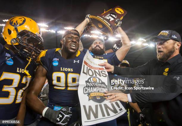 Texas A&M-Commerce Lions Lineman Michael Onuoha, Running Back Richard Whitaker, Lineman Jared Machorro and Head Coach Colby Carthel celebrate the...