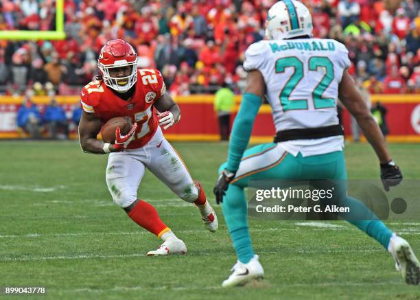 Running back Kareem Hunt of the Kansas City Chiefs rushes up field against strong safety T.J. McDonald of the Miami Dolphins during the first half of...