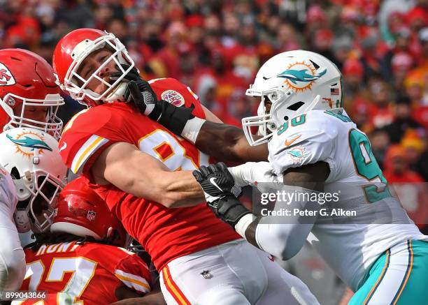 Tight end Travis Kelce of the Kansas City Chiefs gets blocked by defensive end Charles Harris of the Miami Dolphins during the first half of the game...