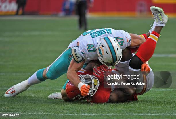 Middle linebacker Kiko Alonso of the Miami Dolphins tackles tight end Demetrius Harris of the Kansas City Chiefs during the second half of the game...