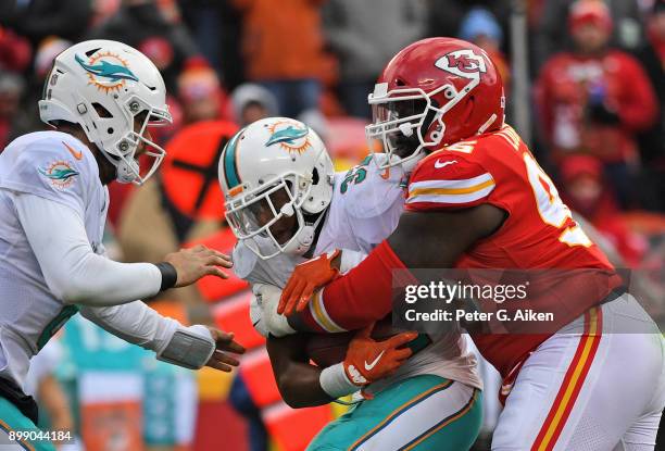 Nose tackle Bennie Logan of the Kansas City Chiefs tackles running back Kenyan Drake of the Miami Dolphins for a loss during the second half of the...