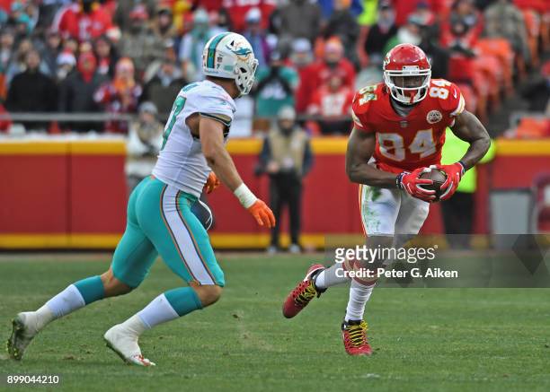 Tight end Demetrius Harris of the Kansas City Chiefs runs up field after catching a pass against middle linebacker Kiko Alonso of the Miami Dolphins...