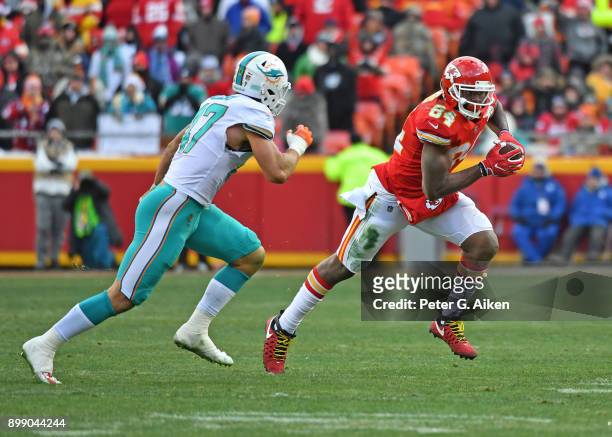 Tight end Demetrius Harris of the Kansas City Chiefs runs up field after catching a pass against middle linebacker Kiko Alonso of the Miami Dolphins...
