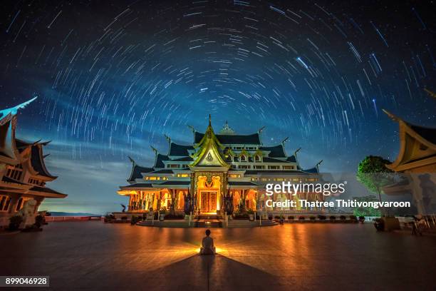 startrail with bright stars and space dust at wat pa phu kon temple, udon thani thailand - udon thani stockfoto's en -beelden