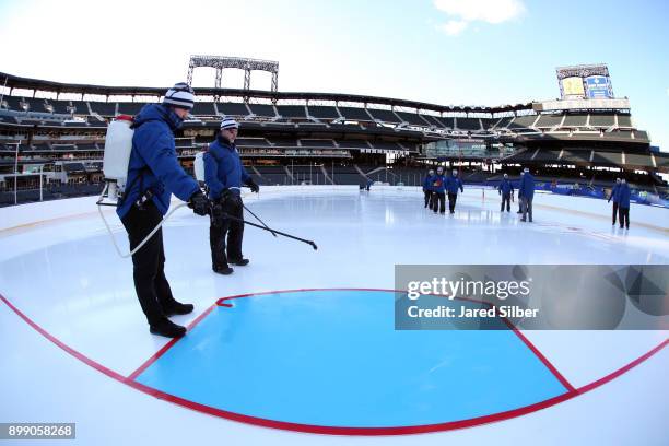 Members of the ice crew install the lines and logos as the rink build process continues at Citi Field ahead of the 2018 Bridgestone NHL Winter...