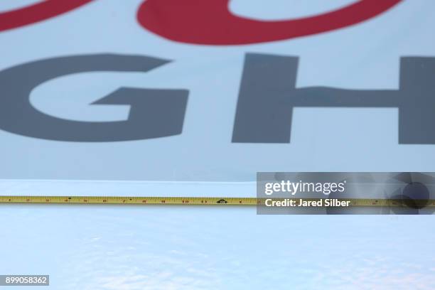 The lines and logos get installed as the rink build process continues at Citi Field ahead of the 2018 Bridgestone NHL Winter Classic between the...