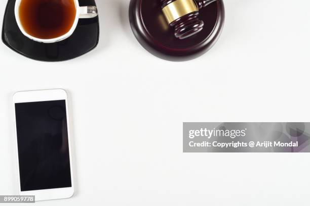 legal firms white office table top view with mobile phone, black tea, judge's gravel flat lay copy area - plaquette de vente aux enchères photos et images de collection