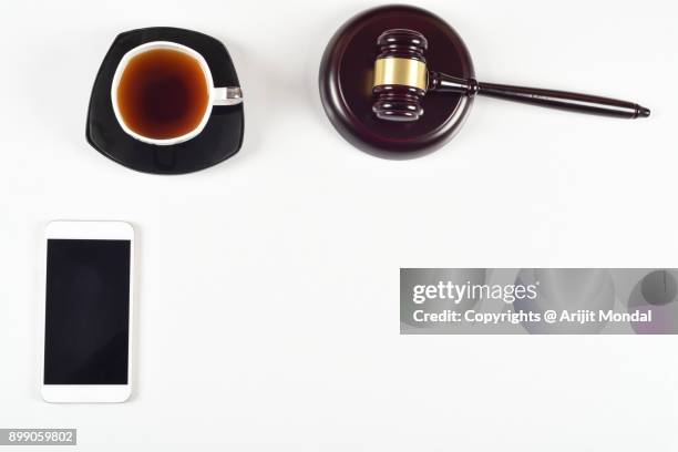 top view, flat lay close up legal concept on a white background justice and law concept with smart phone copy space for text - bid paddle stock pictures, royalty-free photos & images