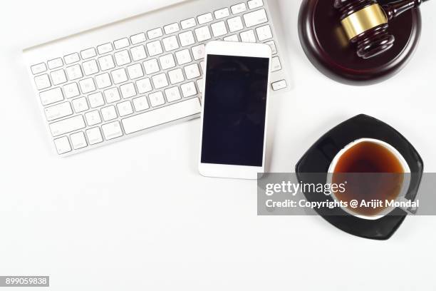 legal concept shot of computer keyboard, smartphone, black tea and judges gravel - bid paddle stock pictures, royalty-free photos & images