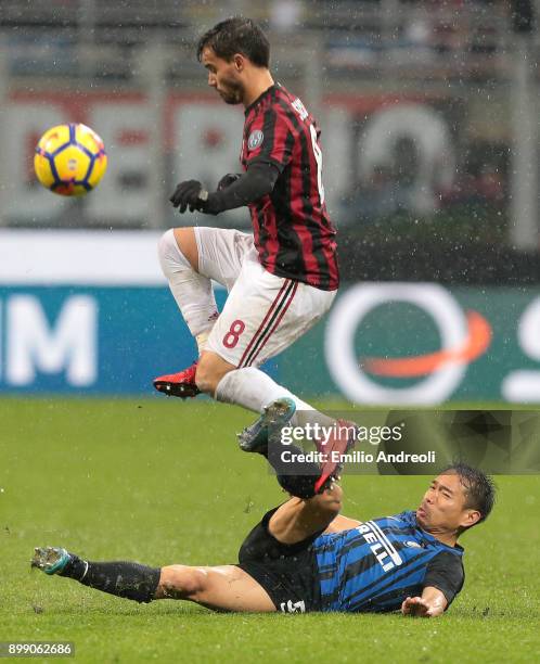 Yuto Nagatomo of FC Internazionale Milano competes for the ball with Fernandez Suso of AC Milan during the TIM Cup match between AC Milan and FC...