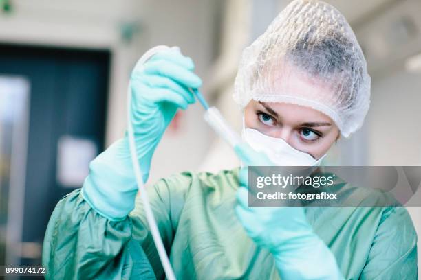 young female scientist working with a pump in laboratory - yeast laboratory stock pictures, royalty-free photos & images