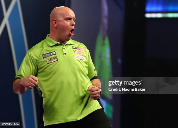 Michael van Gerwen of the Netherlands celebrates during his third round match against Gerwyn Price of Wales on day eleven of the 2018 William Hill...