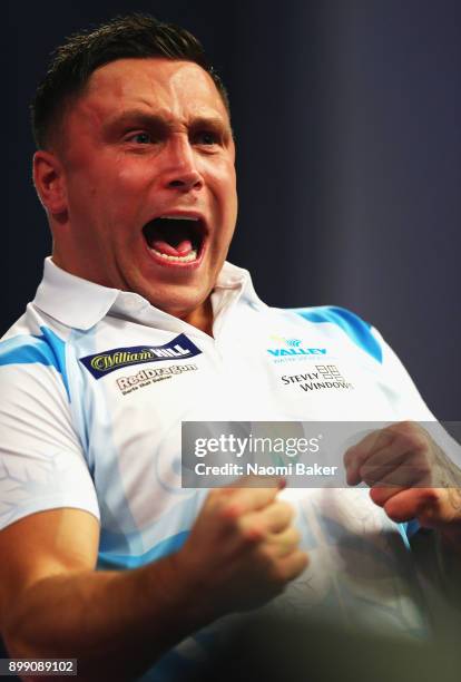 Gerwyn Price of Wales celebrates winning a leg during his third round match against Michael van Gerwen of the Netherlands on day eleven of the 2018...