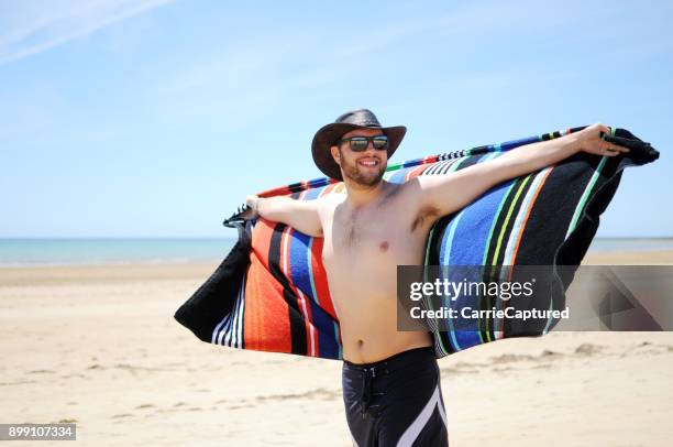 young man at australian beach - board shorts stock pictures, royalty-free photos & images
