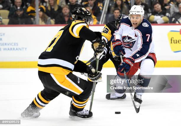 Jack Johnson of the Columbus Blue Jackets skates with the puck as Matt Hunwick of the Pittsburgh Penguins defends in the first period during the game...