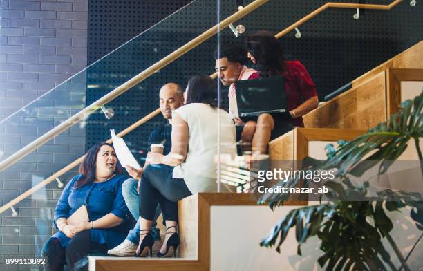 casual team meeting side view. - cultures stock pictures, royalty-free photos & images