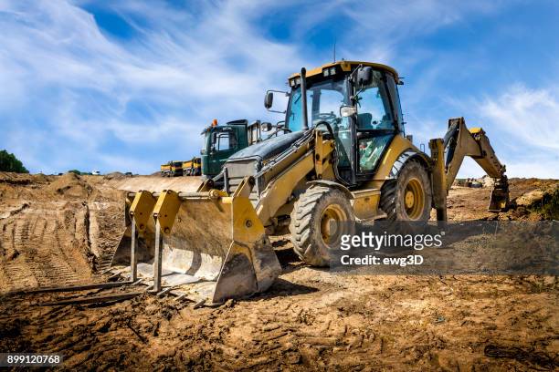 the yellow eart mover on the construction of highway, poland - excavator imagens e fotografias de stock