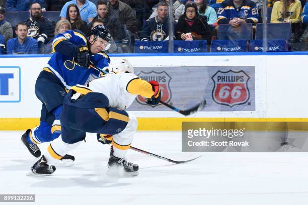 Paul Stastny of the St. Louis Blues takes a shot as Yannick Weber of the Nashville Predators defends at Scottrade Center on December 27, 2017 in St....