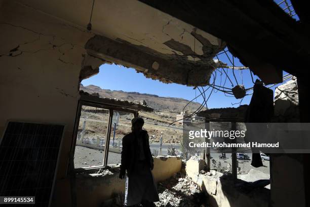 Man inspects a house of 11-members from one family after it was hit by airstrikes carried out by the Saudi-led coalition on Monday leaving the nine...