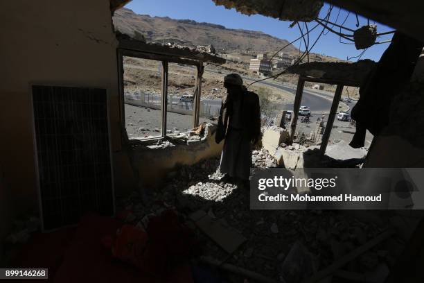 Man inspects a house of 11-members from one family after it was hit by airstrikes carried out by the Saudi-led coalition on Monday leaving the nine...