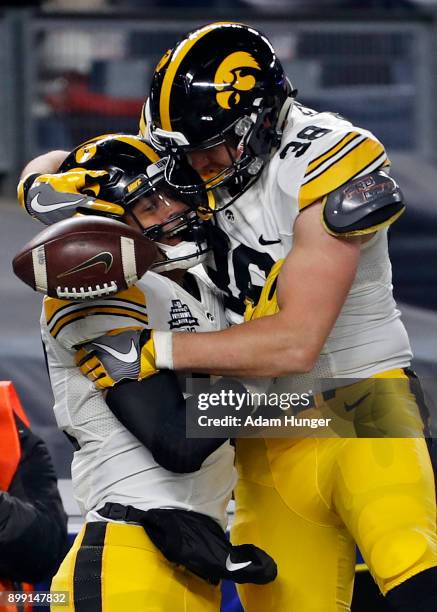 Noah Fant of the Iowa Hawkeyes is congratulated by T.J. Hockenson after scoring a touchdown during the first half of the New Era Pinstripe Bowl...