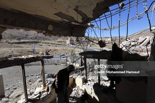 Man inspects a house of 11-members from one family after it was hit by airstrikes carried out by the Saudi-led coalition on Monday leaving the nine...