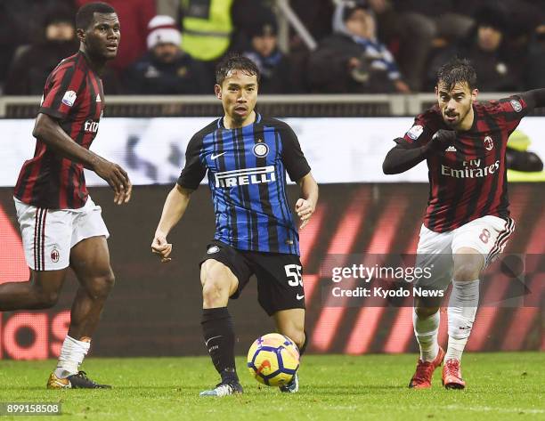 Inter Milan's Yuto Nagatomo is in possession of the ball with AC Milan's Suso in pursuit during the second half of the Italian Cup quarterfinals in...