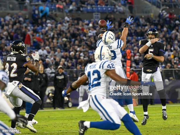 Baltimore Ravens quarterback Joe Flacco completes a pass to tight end Benjamin Watson against the Indianapolis Colts on December 23 at M&T Bank...
