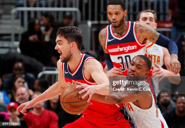 Isaiah Taylor of the Atlanta Hawks attempts a steal against Tomas Satoransky of the Washington Wizards at Philips Arena on December 27, 2017 in...