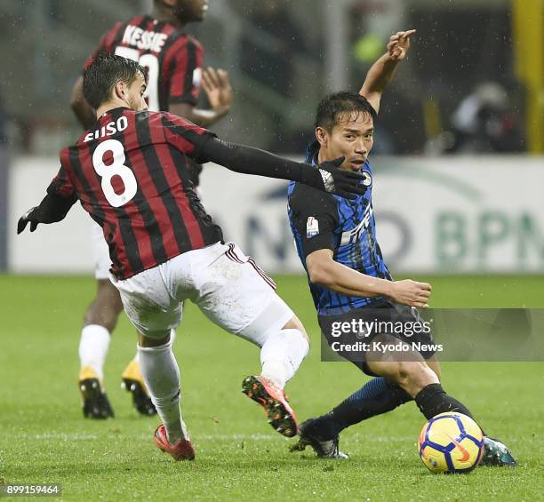 Inter Milan's Yuto Nagatomo vies for the ball with AC Milan's Suso during the first half of the Italian Cup quarterfinals in Milan, on Dec. 27, 2017....