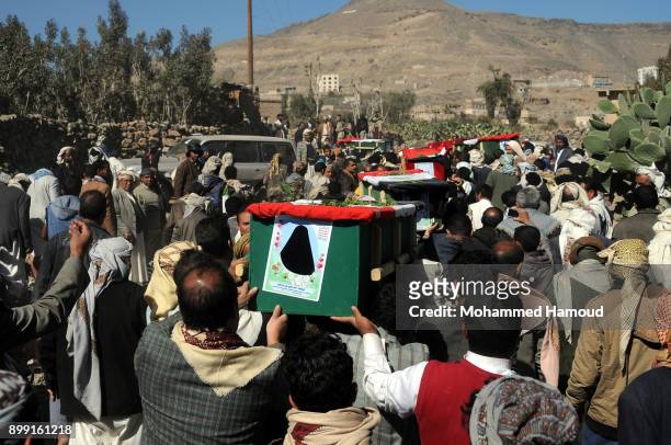 People carry coffins of 11-members from one family after they were killed by airstrikes carried out by the Saudi-led coalition hit their house on...