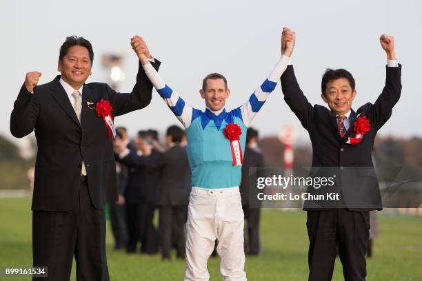 Jockey Hugh Bowman, trainer Yasuo Tomomichi and owner Kazuhiro Sasaki celebrate after Cheval Grand winning the 37th Japan Cup in association with...