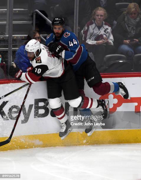 Arizona Coyotes left wing Anthony Duclair and Colorado Avalanche defenseman Mark Barberio both hit the boards during the second period on December...